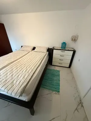a bedroom with a bed and a dresser at Apartman DIJANA BANJA LUKA in Banja Luka