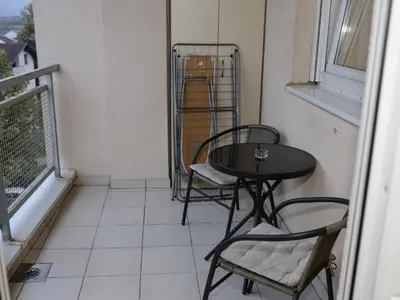 a small table and chairs on a balcony at Iva Lux stan na dan in Banja Luka