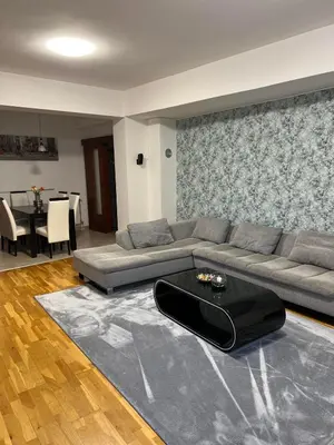 a living room with a couch and a table at Iva Lux stan na dan in Banja Luka