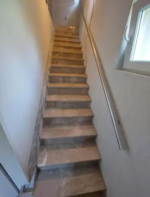 a staircase with wooden steps and a window at L’appartement de la Pyramide du Soleil in Visoko