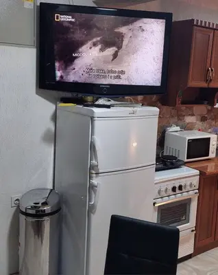 a television on top of a refrigerator in a kitchen at L’appartement de la Pyramide du Soleil in Visoko