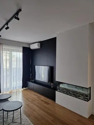 a living room with two tables and a fish aquarium at TOMAS LUX APARTMENTS in Banja Luka