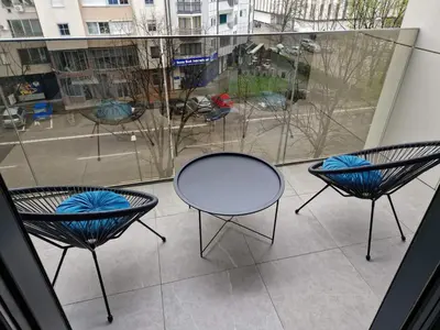 three chairs and a table on a balcony at TOMAS LUX APARTMENTS in Banja Luka
