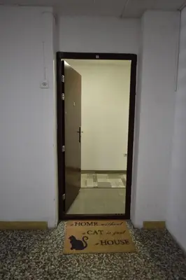 a sign in front of a mirror in a room at Apartman Isidora in Banja Luka