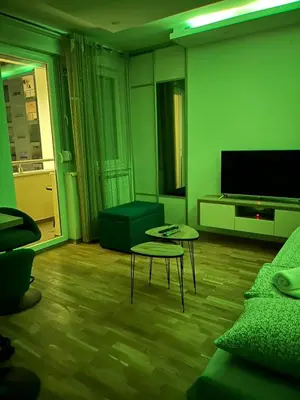 a living room with a couch and a table and a tv at ApartmanM&M in Banja Luka