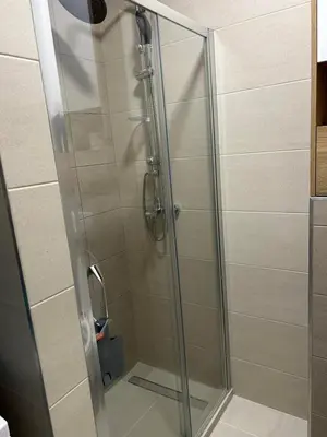 a shower with a glass door in a bathroom at ApartmanM&M in Banja Luka