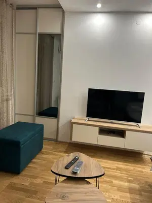a living room with a tv and a couch and a table at ApartmanM&M in Banja Luka
