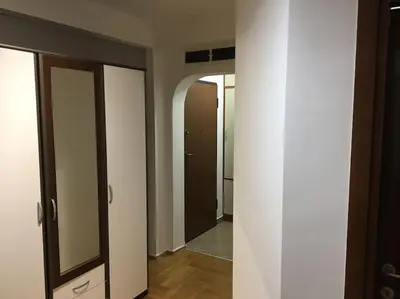 an empty hallway with two doors and a mirror at Apartman DeLUX in Banja Luka