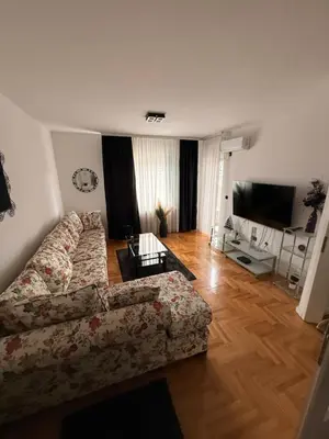 a living room with a couch and a television at Apartman Mirjana in Banja Luka