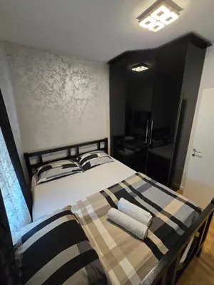 a bedroom with a bed with two towels on it at Apartman Mirjana in Banja Luka