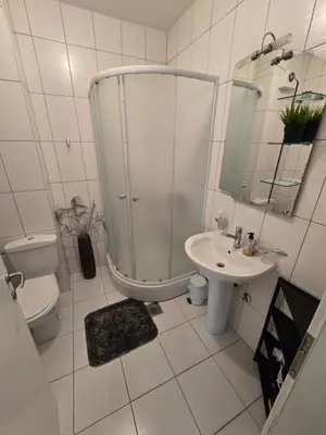 a bathroom with a shower and a toilet and a sink at Apartman Mirjana in Banja Luka