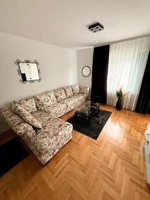 a living room with a couch and a wooden floor at Apartman Mirjana in Banja Luka