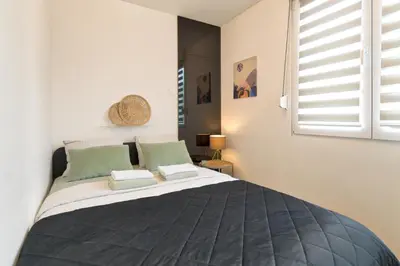 a bedroom with a large bed and a window at Green Oasis in Banja Luka