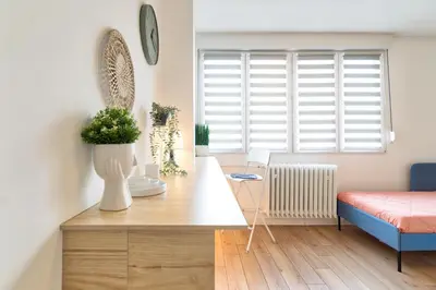 a living room with a desk and a window at Green Oasis in Banja Luka