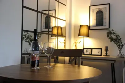 two wine glasses sitting on a wooden table at Green Oasis in Banja Luka