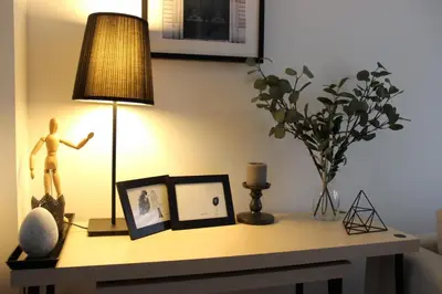 a table with a lamp and a doll on it at Green Oasis in Banja Luka