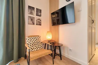 a room with a table and a chair and a tv at Green Oasis in Banja Luka