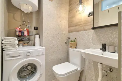 a bathroom with a washing machine and a sink at Green Oasis in Banja Luka
