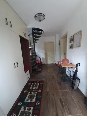 a room with a staircase and a table and a rug at House Na Starom Kućištu in Todorovo