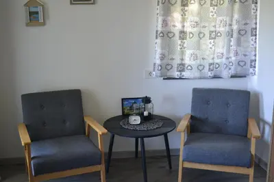two chairs and a table in a room at House Na Starom Kućištu in Todorovo