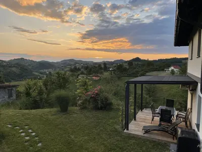a deck with chairs and a table on a house at House Na Starom Kućištu in Todorovo