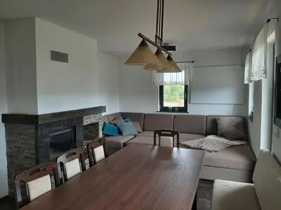 a living room with a table and a couch at House Na Starom Kućištu in Todorovo