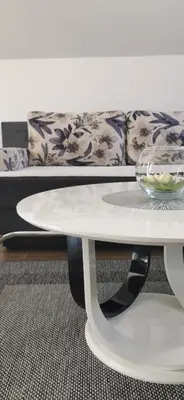 a white coffee table with a couch in the background at Apartments Mario in Drvar