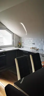 a kitchen with a table and chairs and a window at Apartments Mario in Drvar