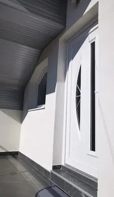 a white door on the side of a house at Apartments Mario in Drvar