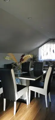 a dining room with a glass table and chairs at Apartments Mario in Drvar