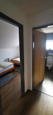 a room with a door and a room with a bed at Apartments Mario in Drvar