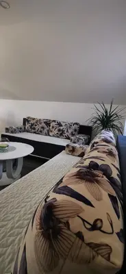 a bedroom with two beds and a table at Apartments Mario in Drvar