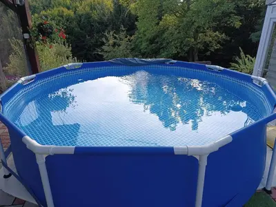 a blue pool with a reflection of the world in it at Guest House Bee in Visoko