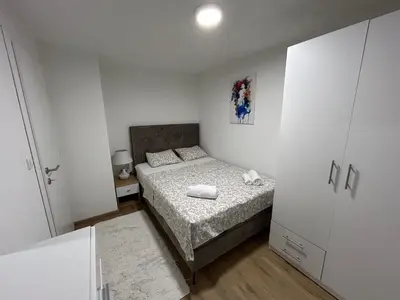 a small bedroom with a bed and a closet at Brand new apartment in Banja Luka