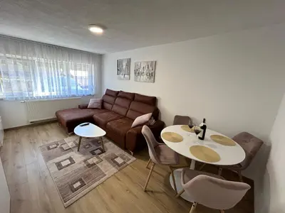 a living room with a couch and a table at Brand new apartment in Banja Luka