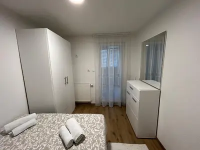 a small bedroom with a bed and a dresser at Brand new apartment in Banja Luka