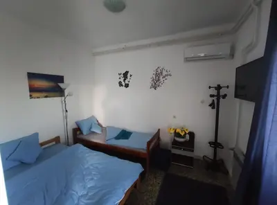 a bedroom with two beds and a tv in it at Apartmani Nova Topola in Nova Topola