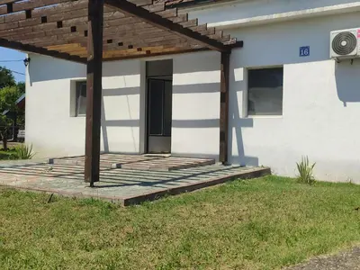 a house with a wooden deck in front of it at Apartmani Nova Topola in Nova Topola