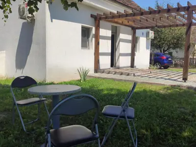 a table and chairs in the yard of a house at Apartmani Nova Topola in Nova Topola