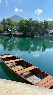a wooden boat sitting in the middle of a lake at House De Luxe in Bihać