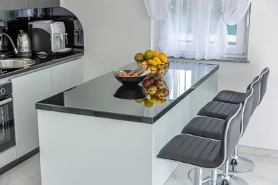 a bowl of fruit on a counter in a kitchen at House De Luxe in Bihać
