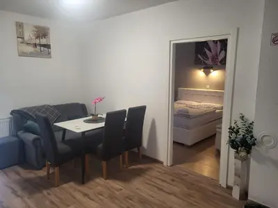 a room with a table and chairs and a bedroom at Apartman D&D 1 in Jajce