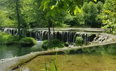 a waterfall in the middle of a river at Apartman D&D 1 in Jajce
