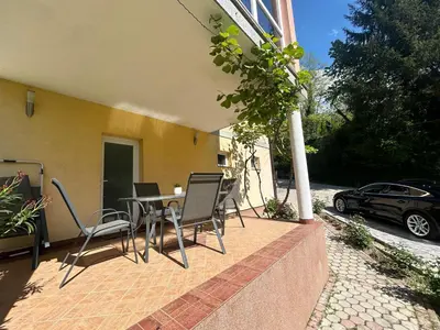 a patio with chairs and a table and a car at Apartman D&D 1 in Jajce
