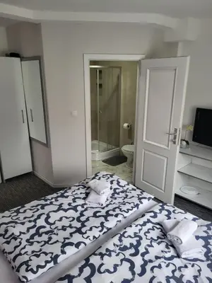 a bedroom with a bed with a blue and white blanket at Apartman D&D 2 in Jajce
