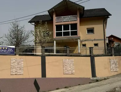 a large house on the side of a road at Apartman D&D 2 in Jajce