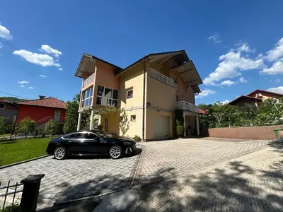 a black car parked in front of a house at Apartman D&D 2 in Jajce