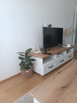 a white entertainment center with a flat screen tv on it at Apartman Vista Banja Luka in Banja Luka