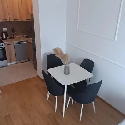 a white table with chairs and a vase on it in a kitchen at Apartman Vista Banja Luka in Banja Luka