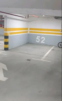 an empty parking garage with a sign on the wall at Apartman Vista Banja Luka in Banja Luka